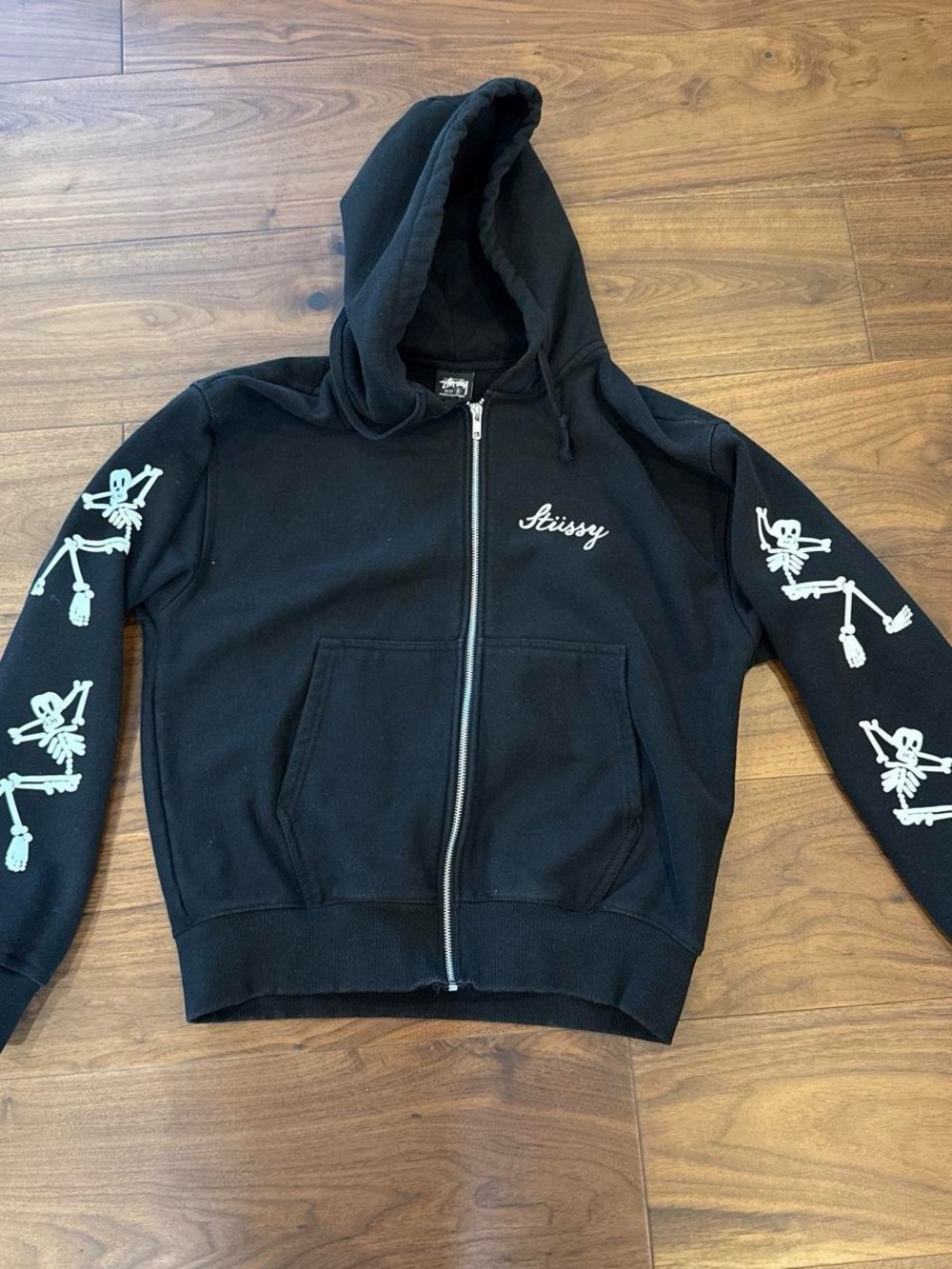 Stussy Black Zip-Up Hoodie with White Skeleton Sleeve Graphics